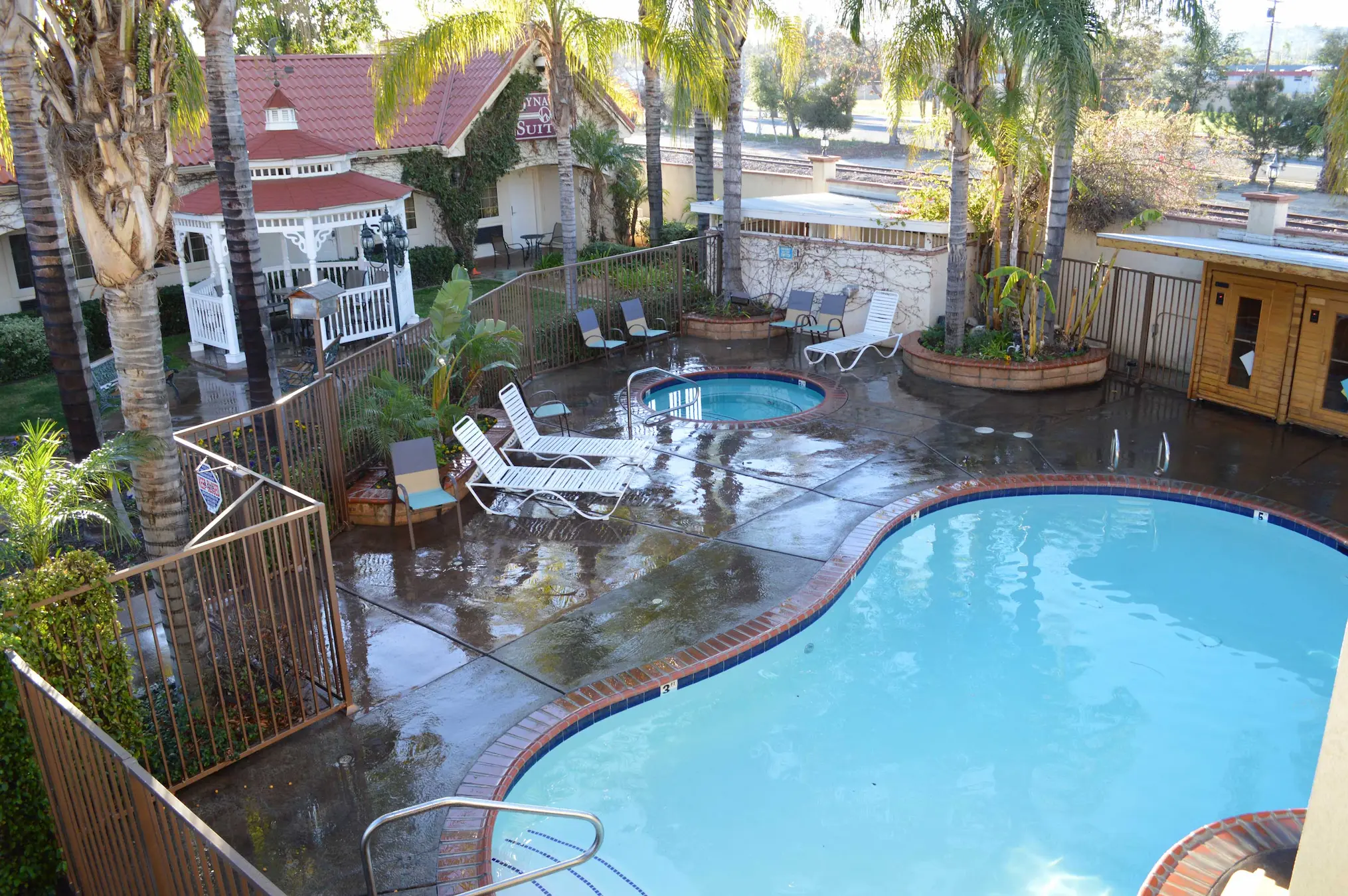 Outdoor pool and hot tub at Dynasty Suites Redlands
