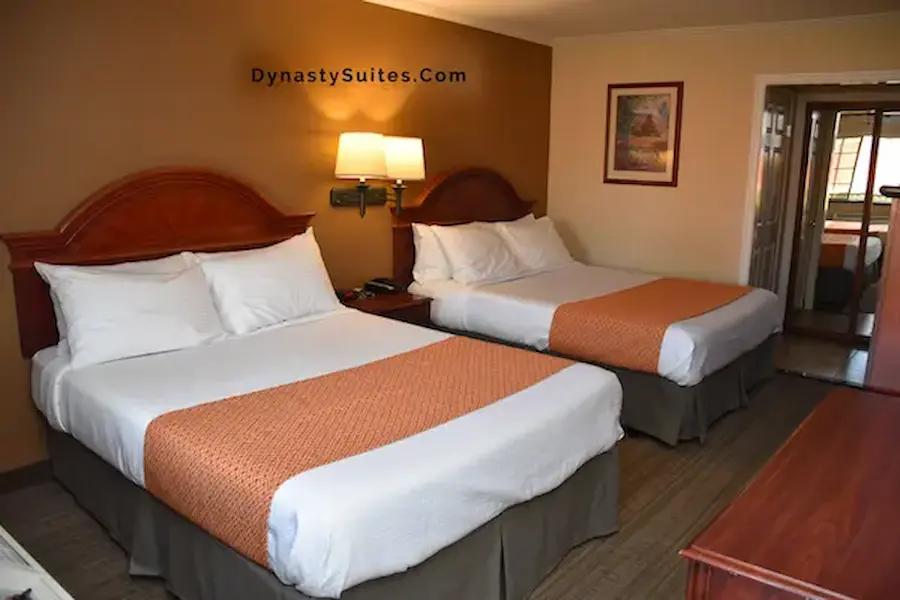 Two queen beds in a Dynasty Suites Redlands guest room